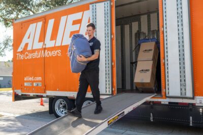 Rose mover carefully unloading a wrapped item from the moving truck